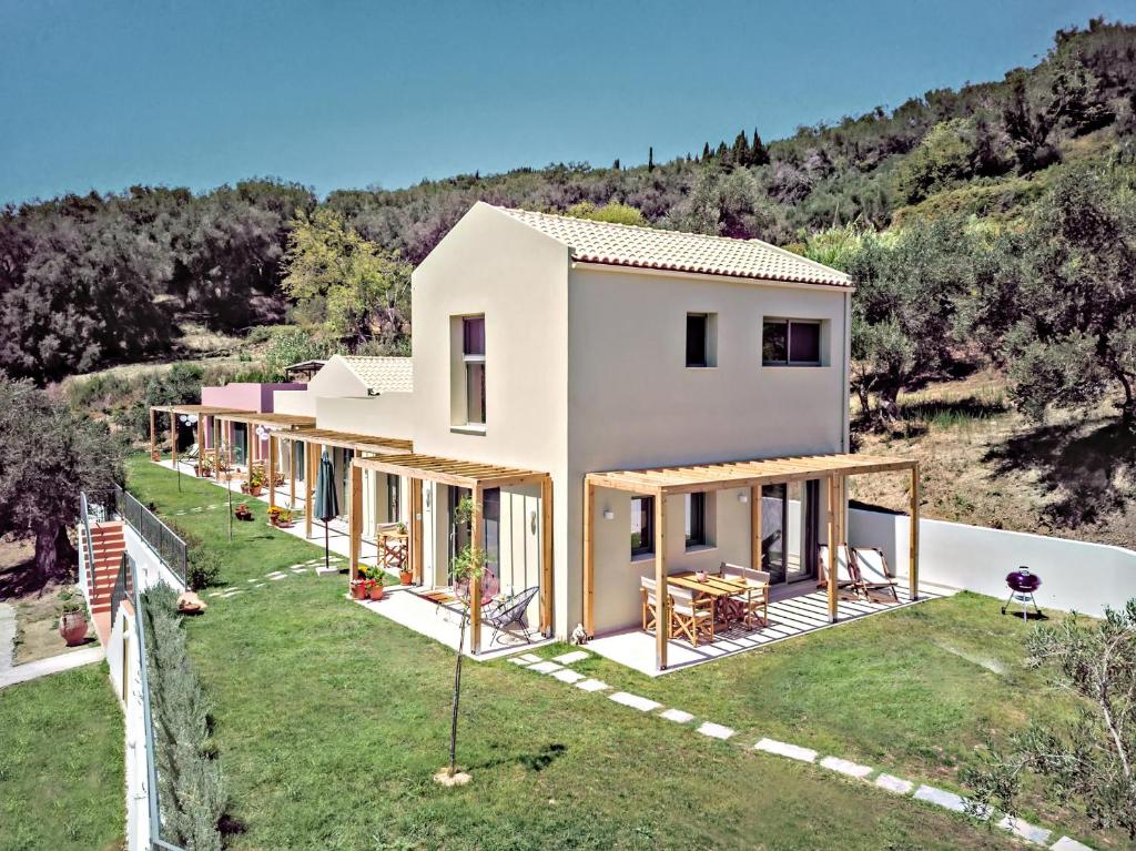 an aerial view of a house in the hills at Kumquart estate- Grape fruit in Aspiotádes