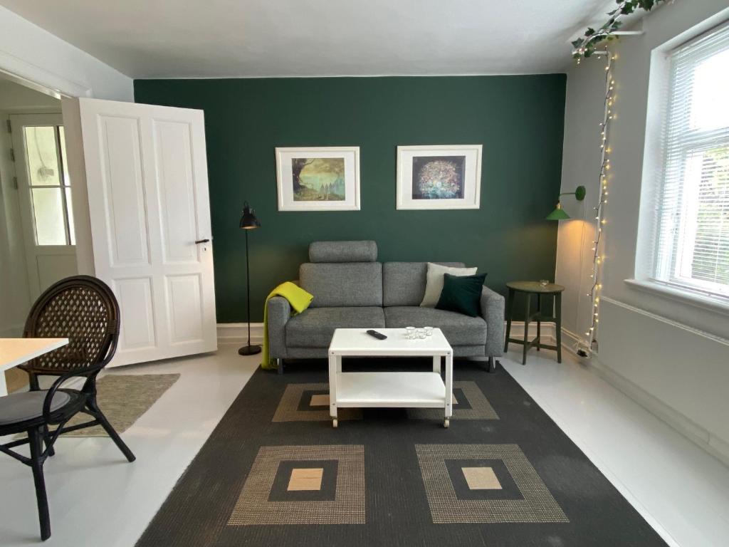 a living room with a couch and a table at City Sleep Svendborg in Svendborg