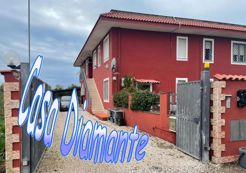 a red house with the word quarantine painted on it at CASA ORCHIDEA in Fiumicino