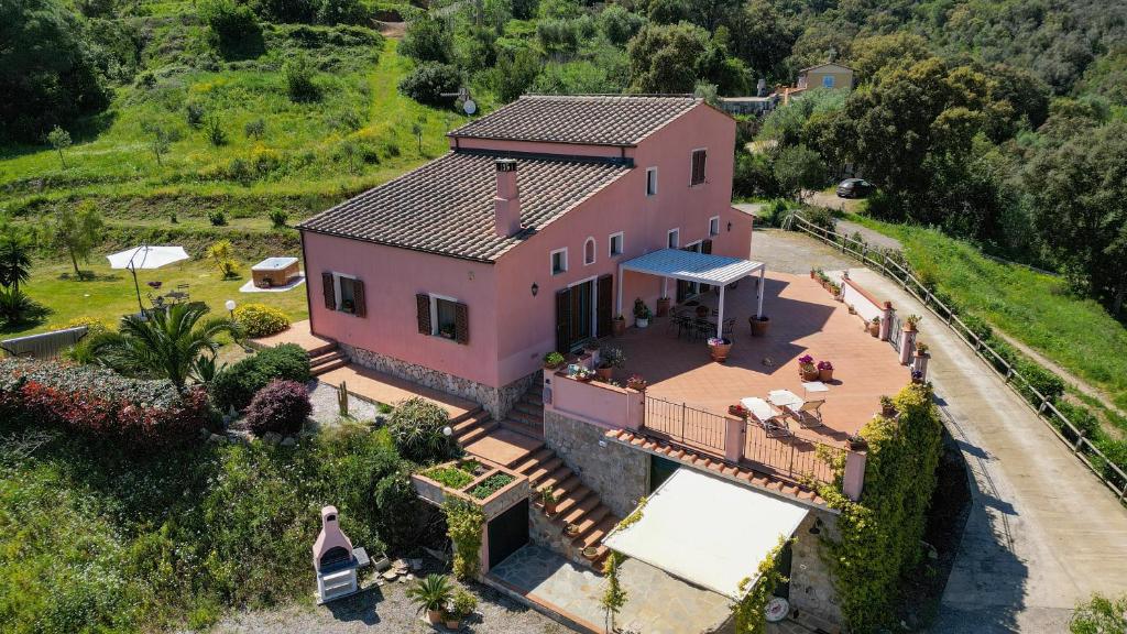 an aerial view of a pink house on a hill at Casalina B & B in Portoferraio