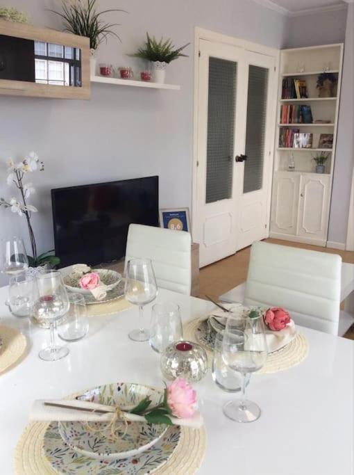 a dining room table with plates and glasses on it at Sobre la villa 12 in Neda