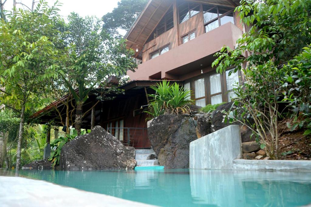 a building with a pool of water in front of a building at Dorala Villa-Your home away home in Kuruwita