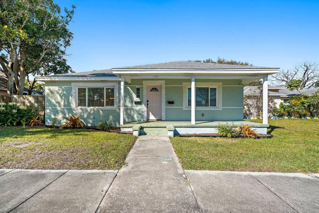 a small blue house with a front door and grass at Curated 2BR/1BA-6 ppl under 1 mile to Downtown in St. Petersburg