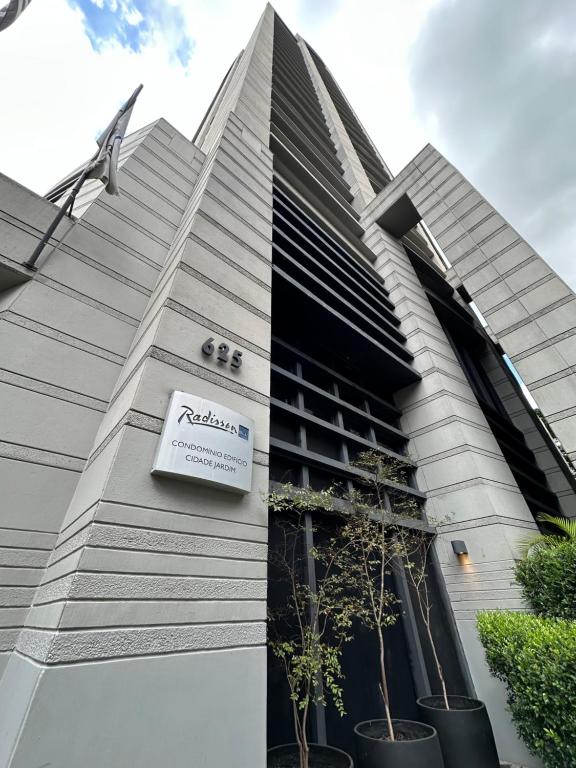 a building with a sign on the side of it at Romastay Itaim SP in Sao Paulo