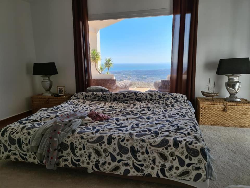 a bedroom with a bed with a view of the desert at Las 2 Lunas in Vélez-Málaga