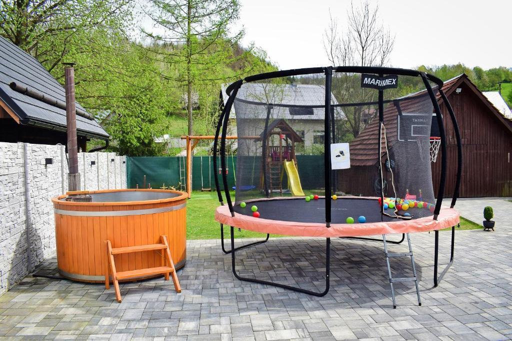 a trampoline in a yard with a playground at Chalupa Martinček in Terchová