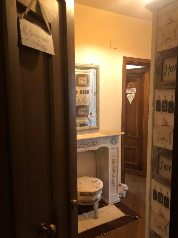 a room with a fireplace and a mirror and a door at Colle House in Rivisondoli