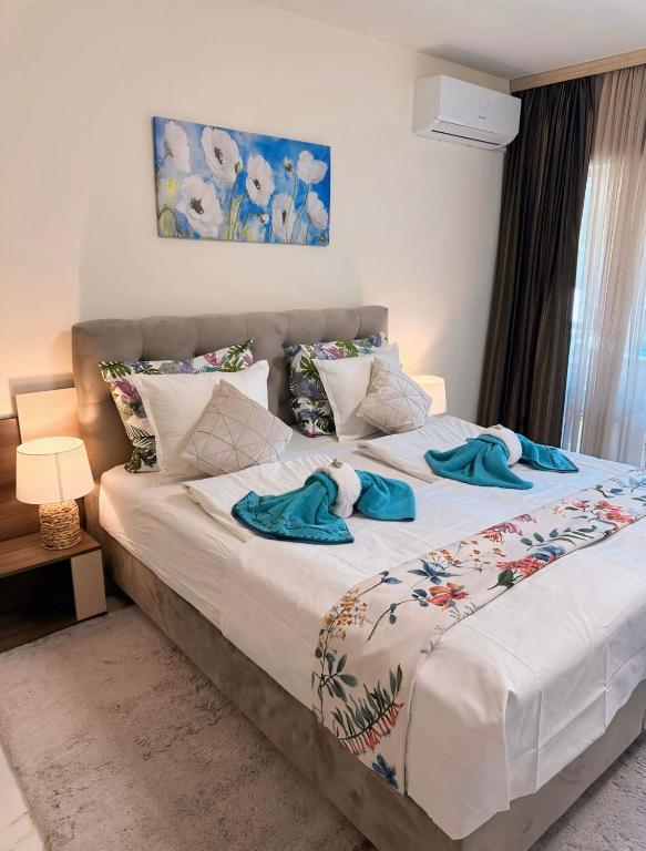 a bedroom with a bed with towels on it at Sea Garden Beach Studio in Saints Constantine and Helena