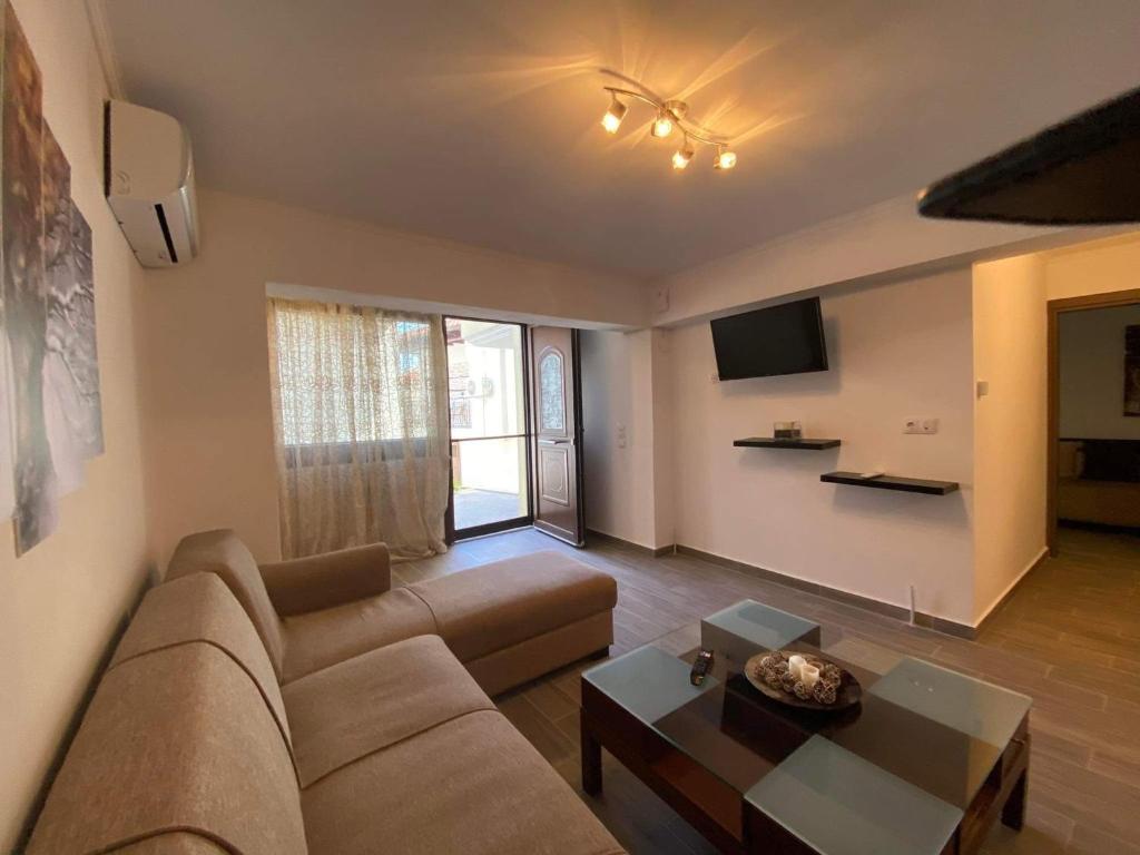 a living room with a couch and a table at Penelope's apartment Ι in Potamiá