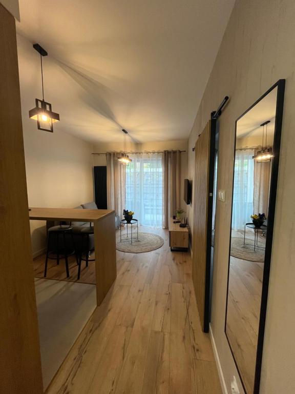 a living room with a table and a dining room at Apartament Tatarska 4B in Przemyśl