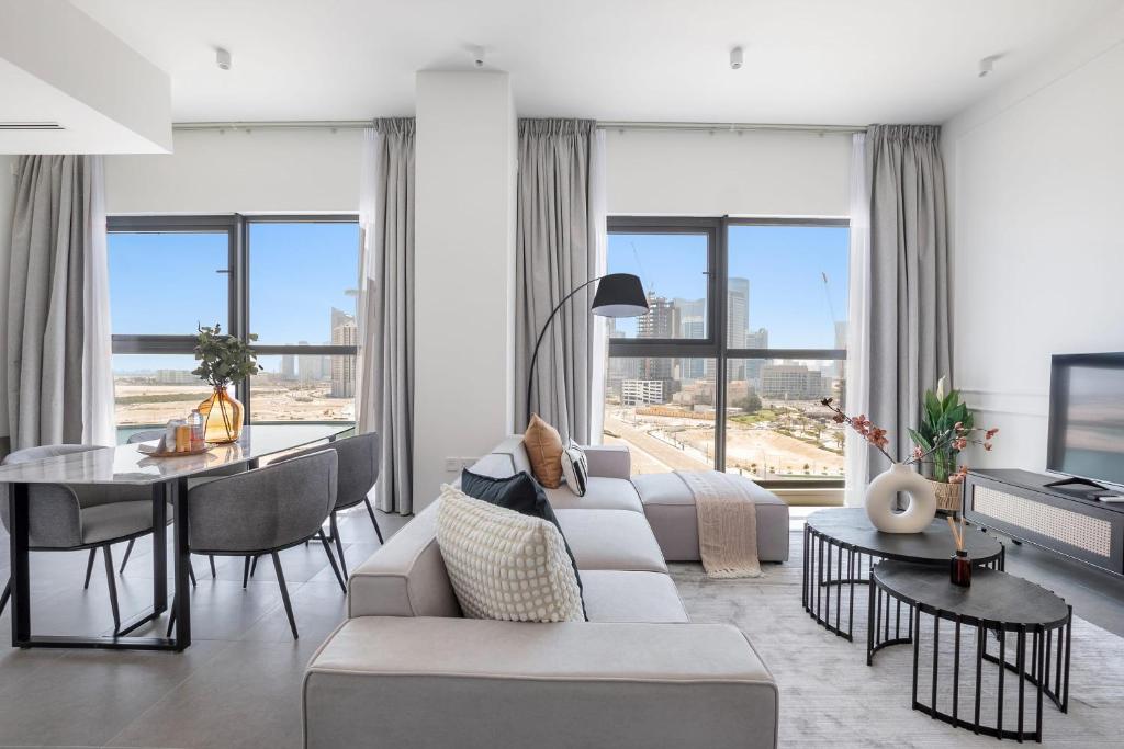 ein Wohnzimmer mit einem Sofa und einem Tisch in der Unterkunft Silkhaus Luxurious 1BDR with Beach Access and City View in Abu Dhabi