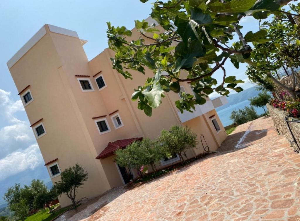a building on top of a brick road at Levi's Villa Radhima in Vlorë