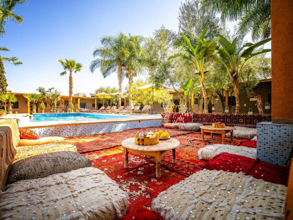 un complejo con piscina y palmeras en Kasbah Alili, en Marrakech