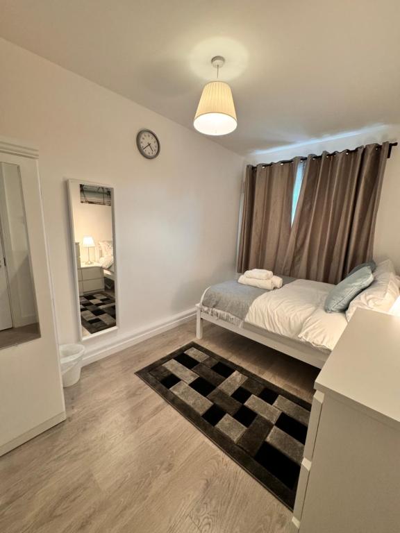 a bedroom with a bed and a mirror at Luxury rooms in Bow in London
