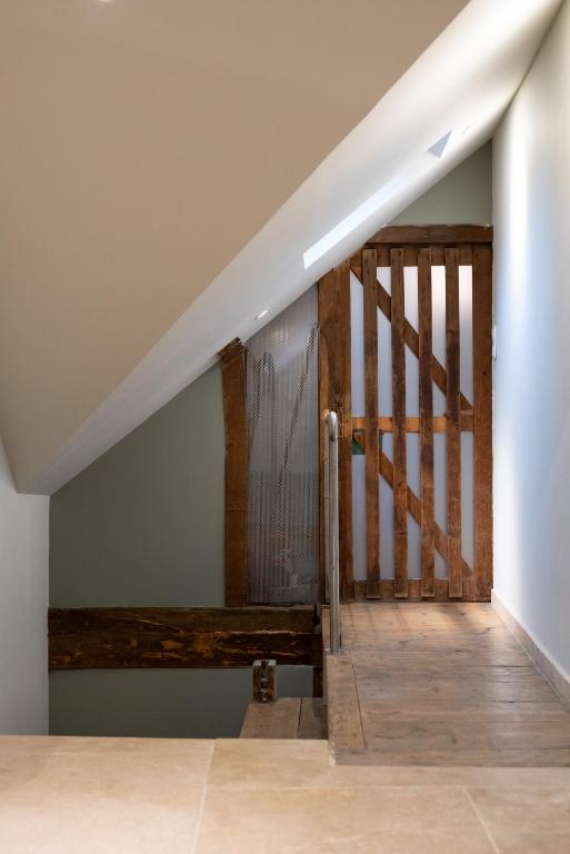 a staircase in a house with a wooden railing at Escale de Giulia in Beaune