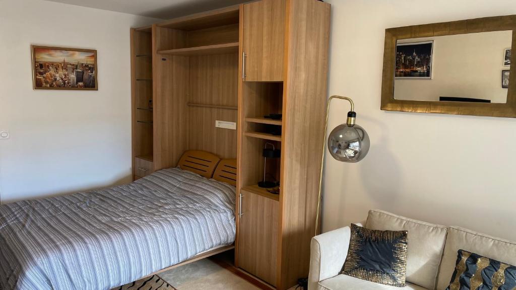 a bedroom with a bed and a book shelf at Un studio de luxe Les Champs Elysées in Paris