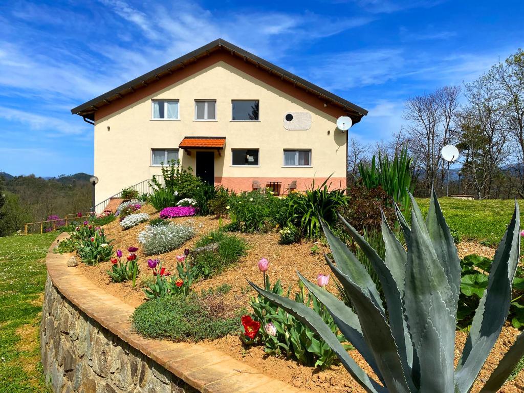 La Casa del Sole في كورفارا: منزل به زهور أمام جدار محافظ