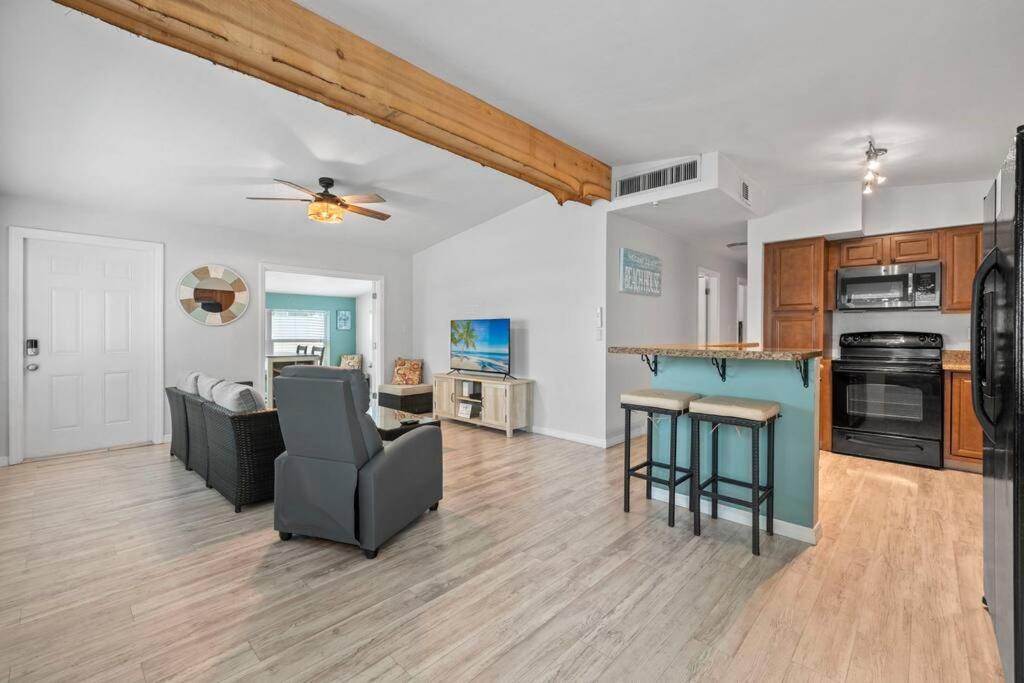 a kitchen and living room with a couch and a table at The Home Away From Home in Fort Myers