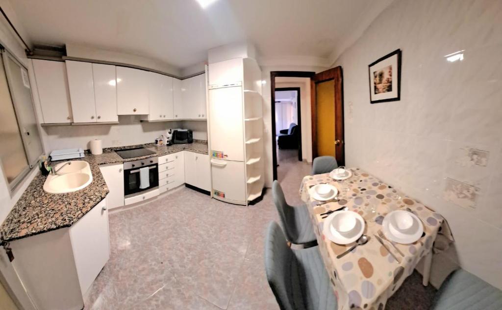 a kitchen with a table and chairs in a room at Gabriella Apartment Near the beach in Puerto de Sagunto