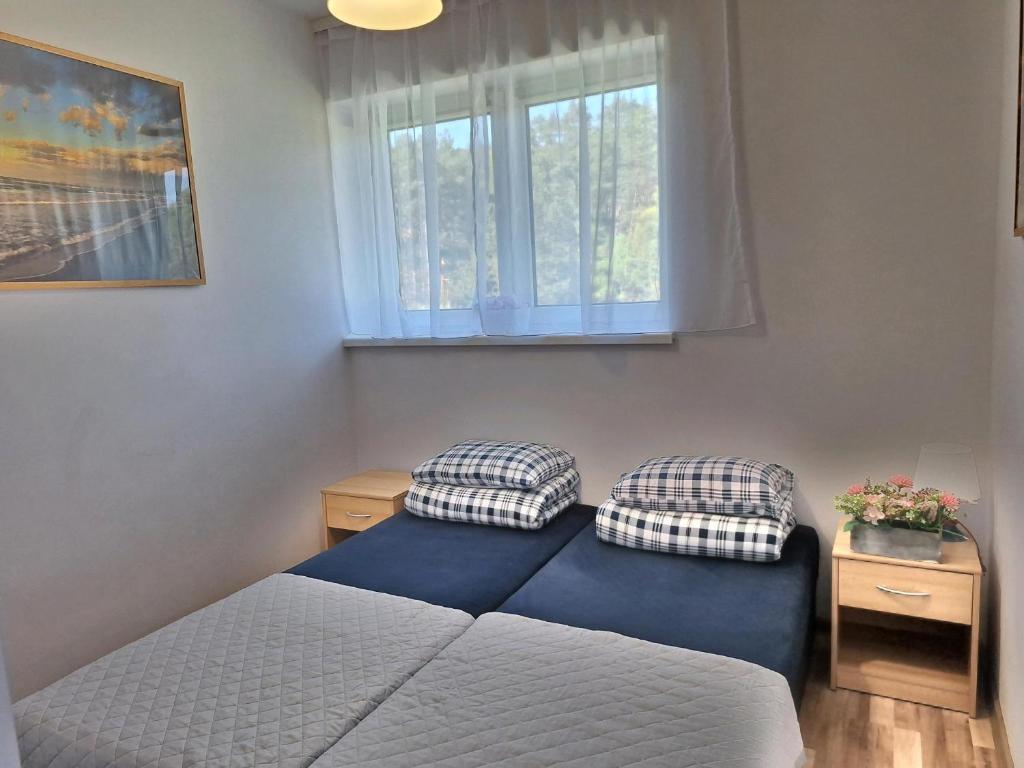 Postel nebo postele na pokoji v ubytování Leśne Zacisze