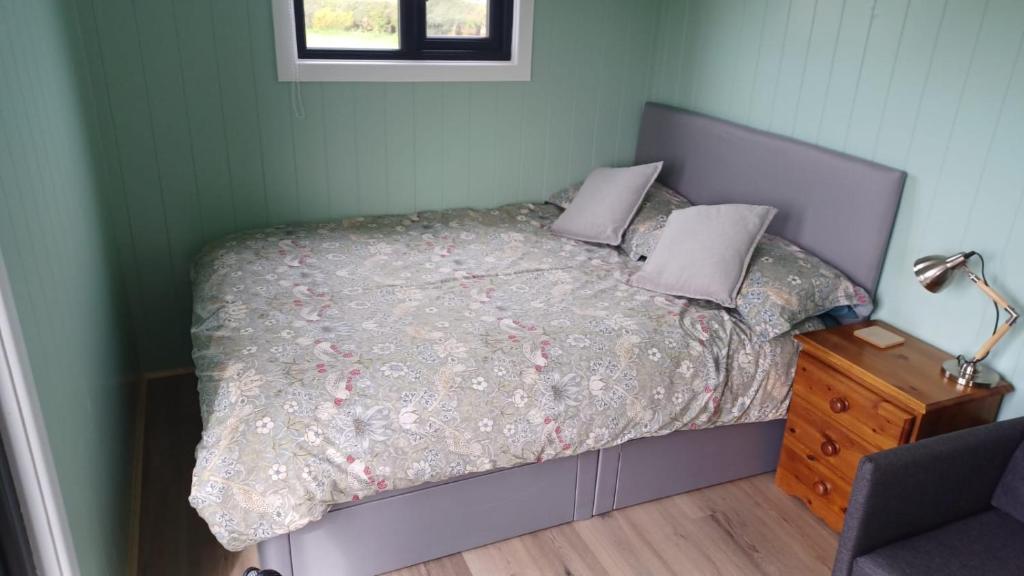 A bed or beds in a room at Cwtch Winnie Shepherd's Hut- Pen Cefn Farm Holiday