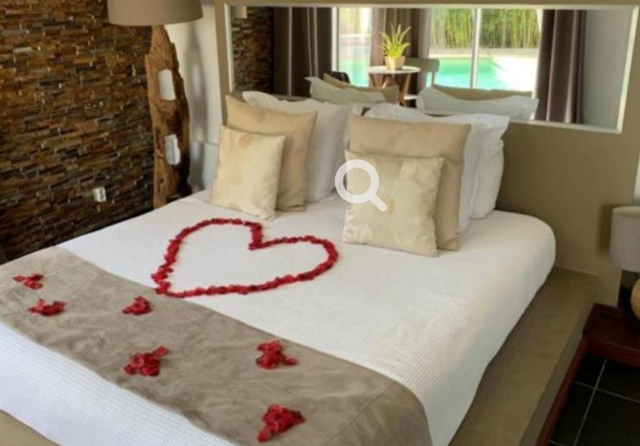 a bed with a heart made out of red flowers at Hotel & Casa de Charme Estadio Morumbi 24 Hs in Sao Paulo