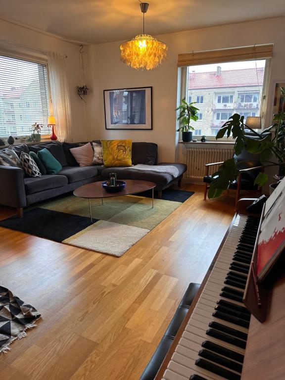 a living room with a couch and a piano at Eurovision apartment in central Malmö in Malmö
