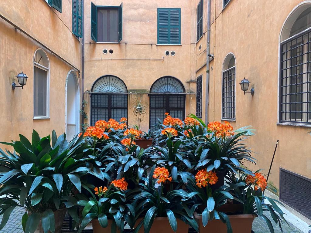 a bunch of plants in front of a building at Veneto Suite 2 by SupaStays - King room in Rome