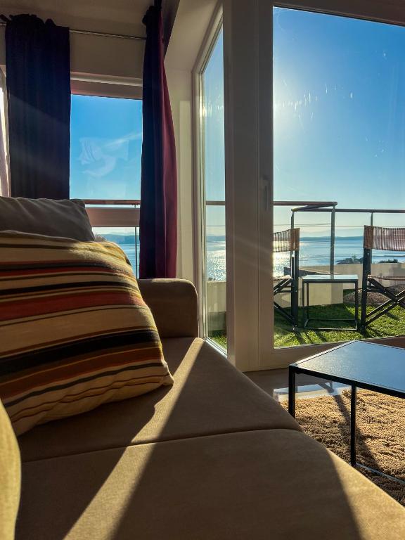a living room with a couch and a view of the ocean at SUNADOR - Adults Only in Crikvenica