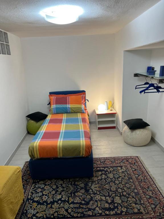 a bedroom with a bed with a colorful blanket at Casa Vacanze Manzoni 29 in Cagliari