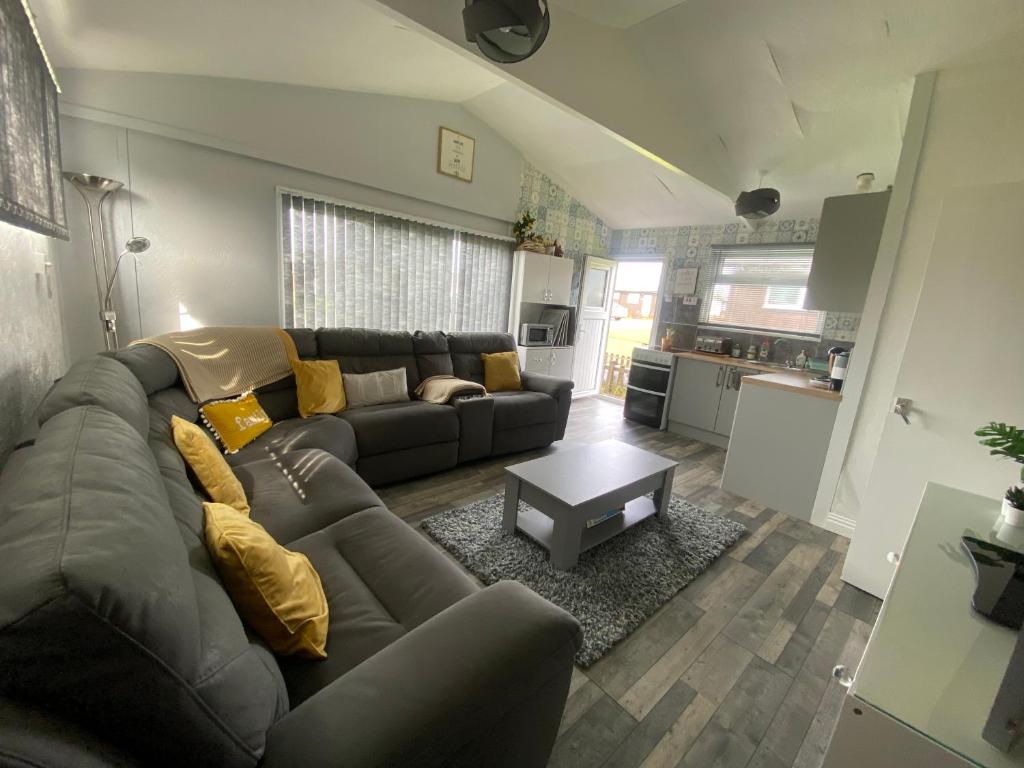 a living room with a couch and a table at 348 Golden Sands in Withernsea