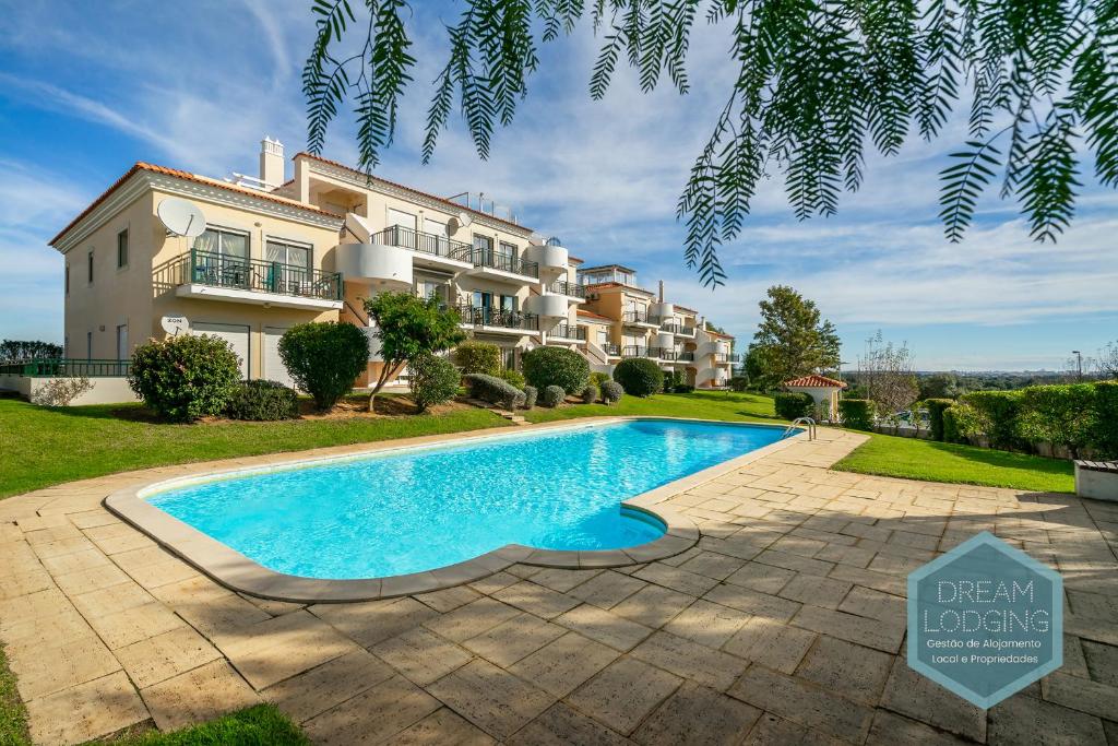 a swimming pool in front of a house at Quinta do Paiva 10A Dream Lodging in Albufeira