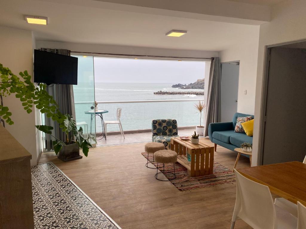 a living room with a view of the ocean at frente al mar San Bartolo in San Bartolo