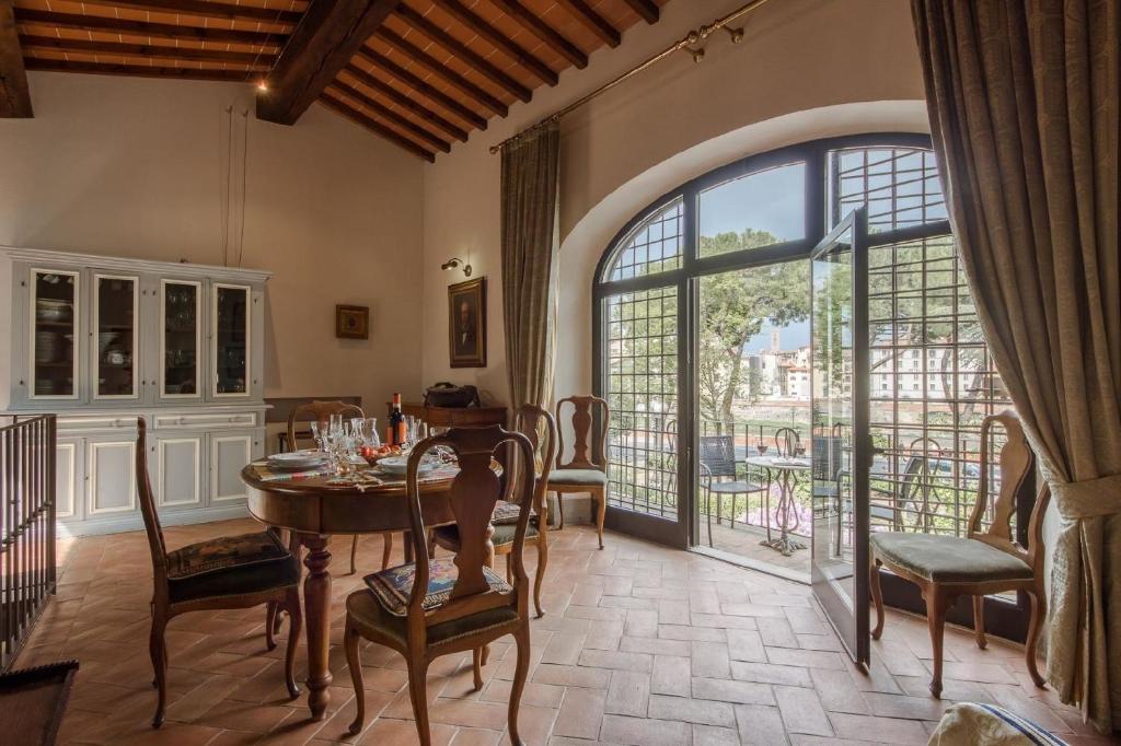 comedor con mesa y ventana grande en Ferienwohnung für 5 Personen ca 150 qm in Florenz, Toskana Provinz Florenz, en Florencia