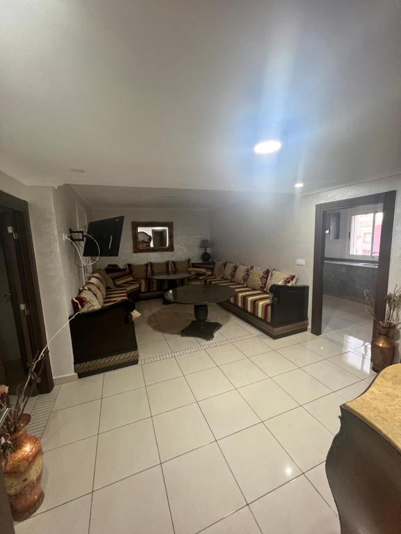 a living room with a couch and a table at Nador El jadid in Nador
