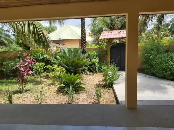 a view of a garden from inside a house at Chez Jacques Diatta in Cap Skirring