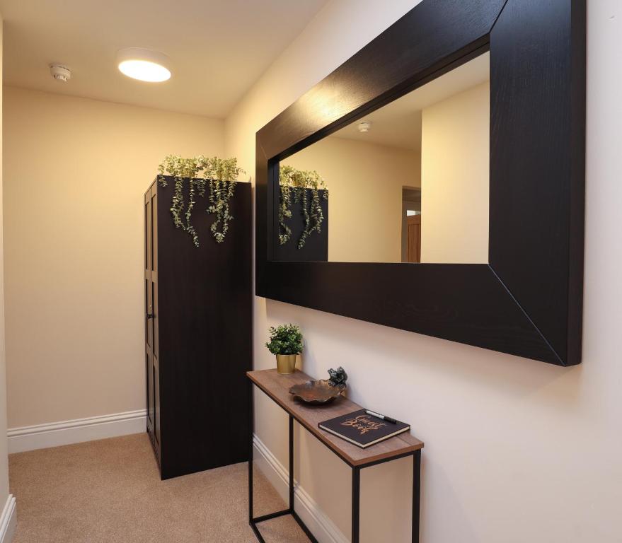a bathroom with a large mirror and a table at Quite and comfortable Eastbourne in Eastbourne