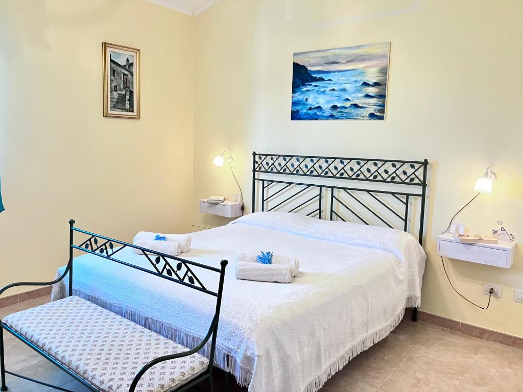 a bedroom with a bed and a chair in it at Beautiful apartment 100mt from the sea in Porto Torres