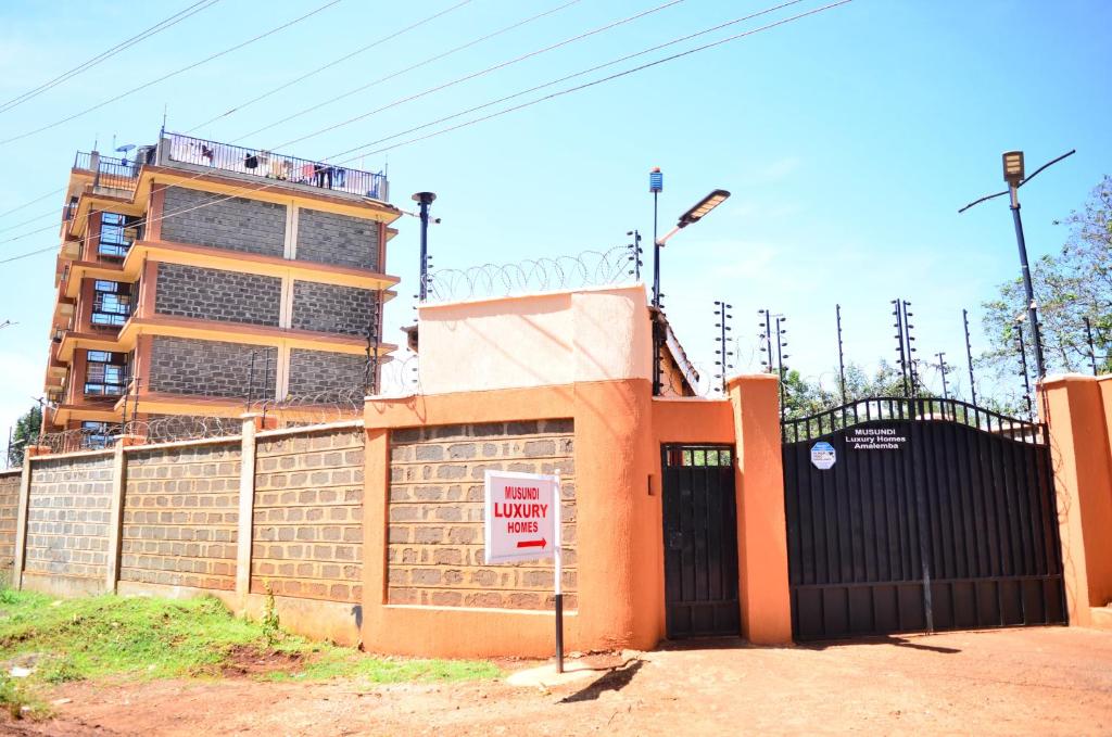 a building with a gate in front of a building at Musundi Luxury Homes in Kakamega