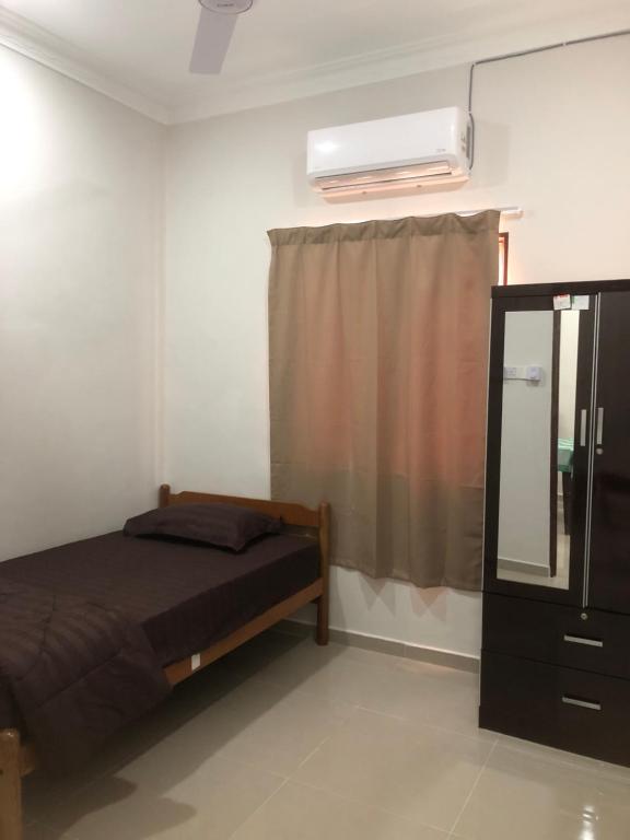 Postel nebo postele na pokoji v ubytování Homestay Siti Klang