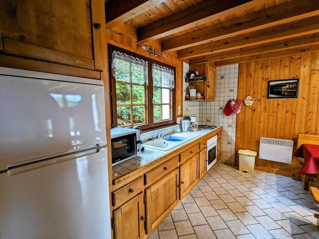 a kitchen with a refrigerator and a sink at Gîte Anould, 4 pièces, 6 personnes - FR-1-589-2 in Anould