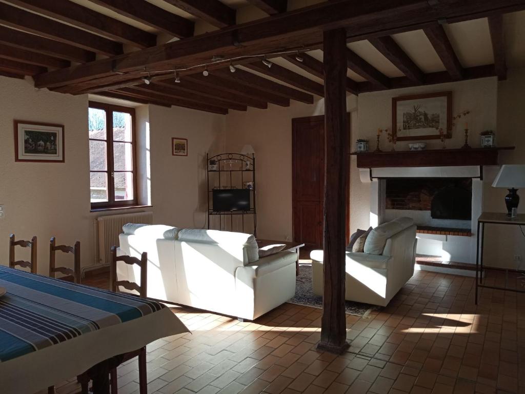 a living room with two white couches and a fireplace at Gîte Arthon, 5 pièces, 8 personnes - FR-1-591-372 in Arthon