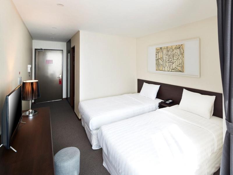 Postel nebo postele na pokoji v ubytování Hotel K-Tree Pyeongtaek