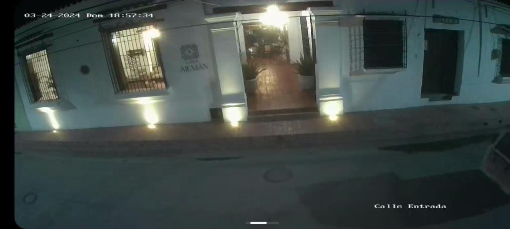 een persoon die 's nachts voor een gebouw staat bij HOTEL CASA ALEMAN EN MOMPOX CON PARQUEADERO Y PISCINA CENTRO HISTORICOo in Mompós