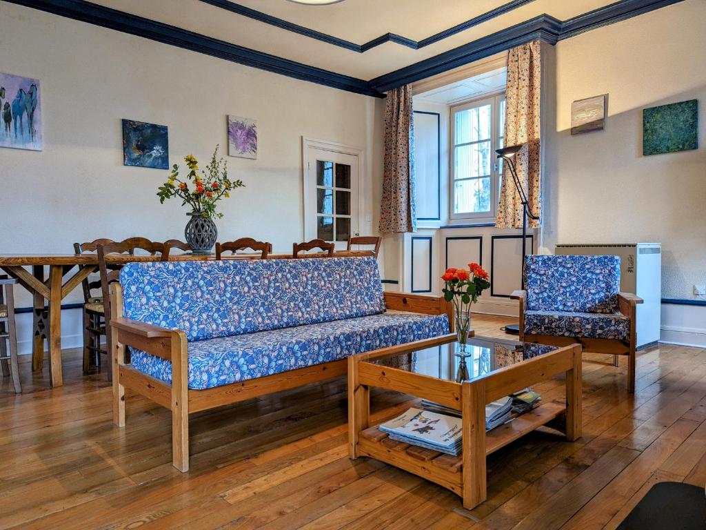 a living room with a couch and a table at Maison indépendante avec terrasse et jardin clos à Yssingeaux, proche loisirs et commerces - FR-1-582-144 in Yssingeaux