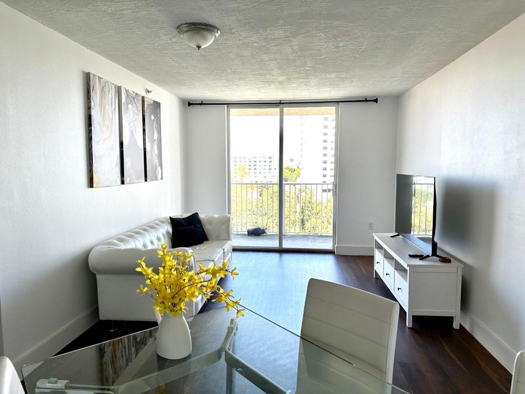 a living room with a couch and a glass table at Private bedroom 1 block from Downtown Miami in Miami