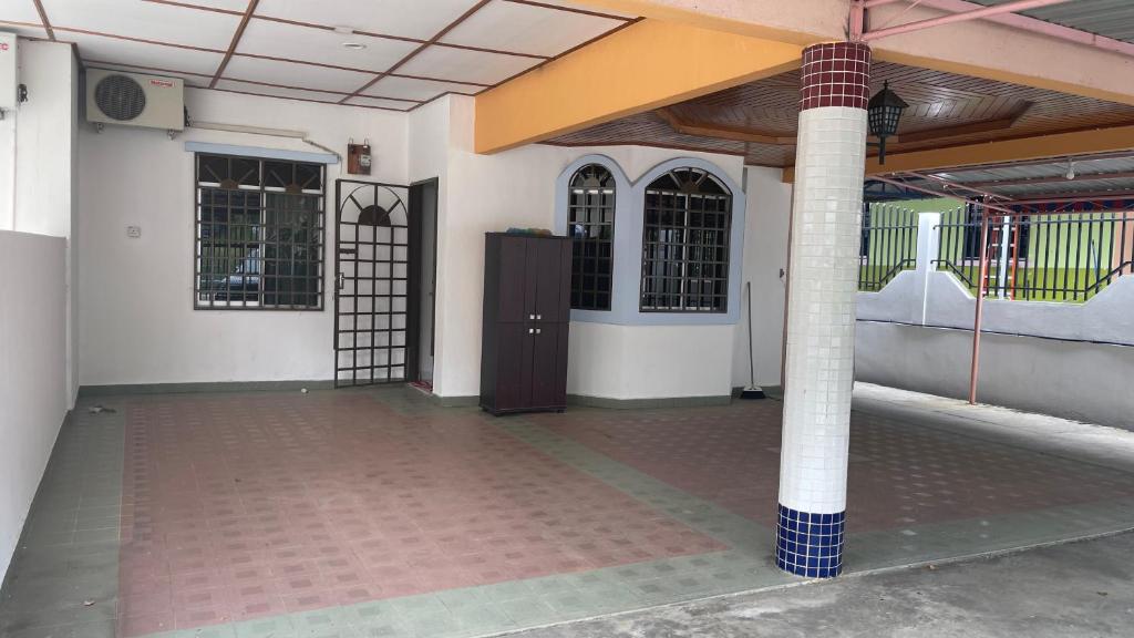 an empty building with a gate and a pillar at Homestay Taman Bahagia in Tenom
