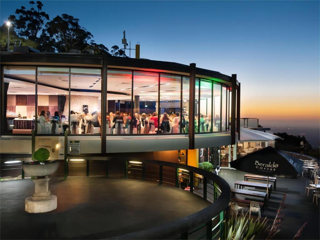 a group of people standing on top of a building at Modern Seednest Treehouse, Forest & Mountain View in Sassafras
