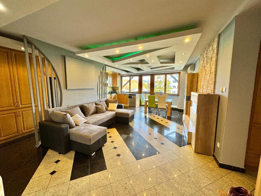 duży salon z kanapą i stołem w obiekcie Bem Apartman w Debreczynie