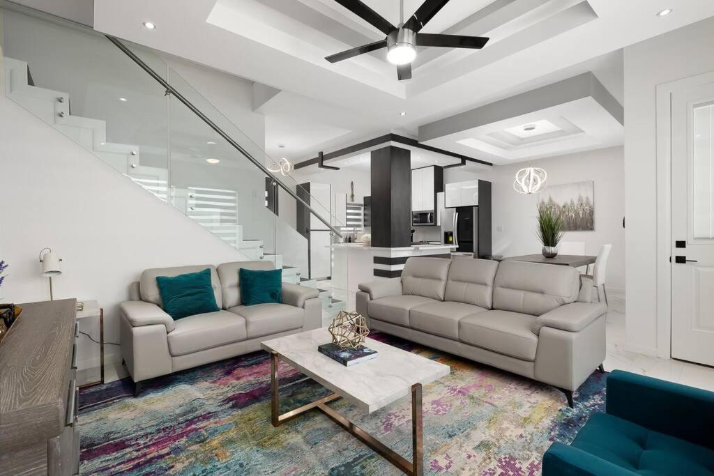 a living room with two couches and a table at Quinta Real 4905 in McAllen